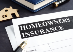 Homeowner insurance mentioned on a paper with a pen near it